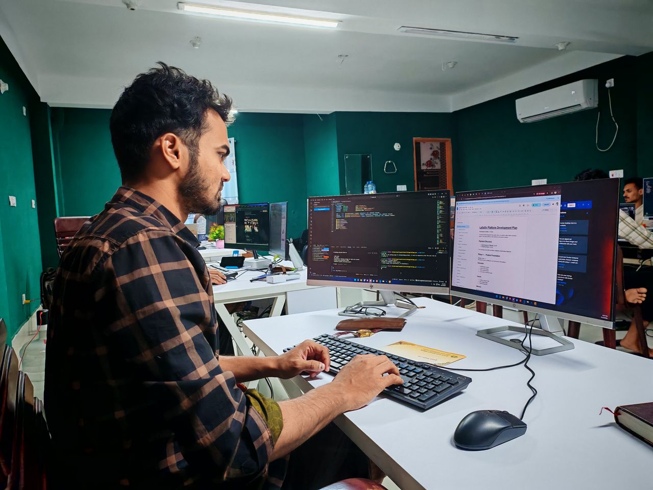 Mastering the First Impression: Your intriguing post title goes here A software developer working on code at a dual monitor setup in a modern office.
